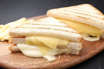 Tasty sandwiches with melted cheese on gray table, closeup