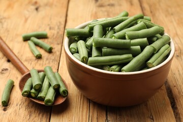 Many raw green beans on wooden table, closeup