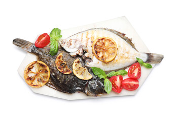 Tasty roasted flounder fish with tomatoes, basil and lemon slices isolated on white, top view. Homemade seafood dish