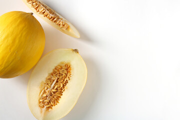 Whole and cut ripe melons on white background, flat lay. Space for text