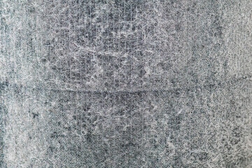 dirty air filter clogged with dust, lint, and pet hair. The textured surface shows heavy buildup, representing poor indoor air quality, pollution, allergens, and the need for filter cleaning