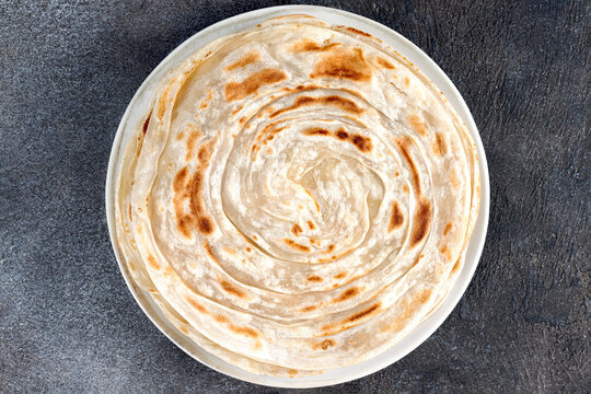 Traditional Indian paratha on gray background. Indian food. Top view. Close up