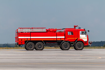 Red airfield fire engine truck at the airport