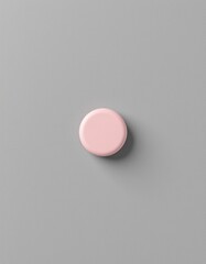 A single, round, pastel pink object set against a smooth, muted gray background, The object appears to be a soft, matte surface with minimal texture, capturing a gentle, calming aesthetic