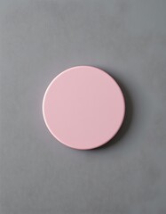 A single, round, pastel pink object set against a smooth, muted gray background, The object appears to be a soft, matte surface with minimal texture, capturing a gentle, calming aesthetic