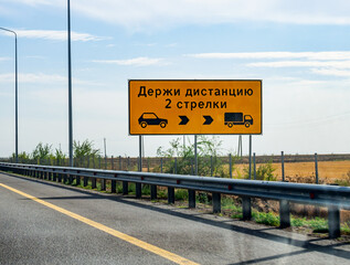 Road sign for maintaining a safe distance between cars