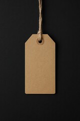 Brown Kraft Tag Hanging on Twine Against Dark Paper Background