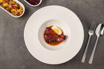 Barbecue pork slices with hard-boiled egg in a savory brown sauce