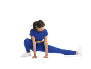 Obraz premium Teenage girl in sportswear stretching on white background