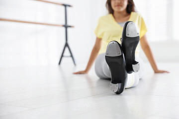 Teenage girl in tap shoes indoors, closeup