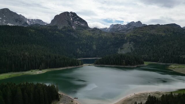 Cinematic 4K drone video flying forward over Crno Jezero Black Lake Montenegro in Durmitor National Park