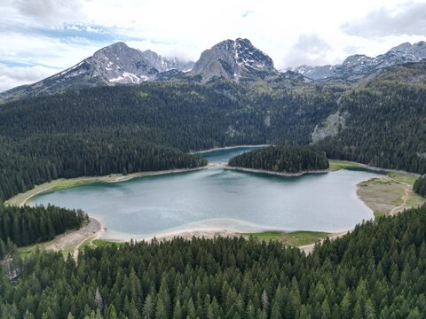 Drone panoramic shot of Black Lake Crno Jezero in Durmitor National Park Montenegro with mountain backdrop