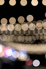 Out-of-focus lights create a bokeh effect with overlapping circular shapes against a dark background.