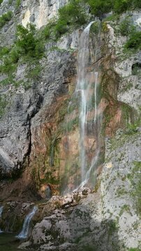 4K aerial drone video close-up of waterfall cascading down rocky mountain Montenegro