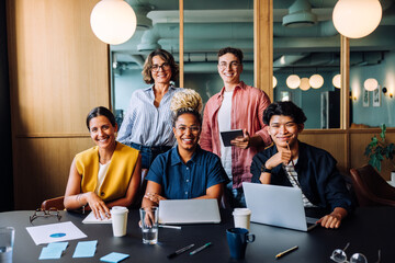 Group of colleagues smiling and working together in an office setting