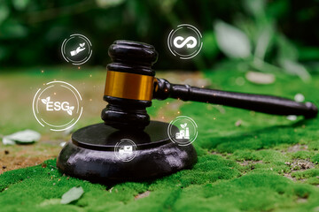 A gavel sits on lush green moss, surrounded by icons representing environmental, social, and governance themes, emphasizing sustainability and ethical responsibility.