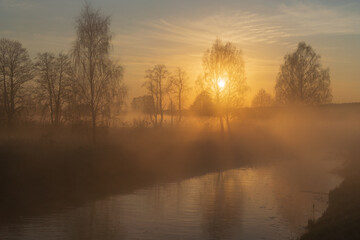 morning mist over the river with rising sun