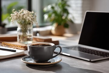 Modern workspace featuring a laptop, coffee cup, and plant under natural light in a cozy setting encouraging productivity and focus for remote work
