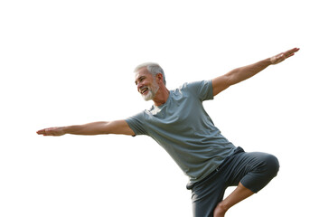 A healthy senior man with a cheerful smile displays impressive balance in a dynamic pose, embodying an active lifestyle and overall well-being.