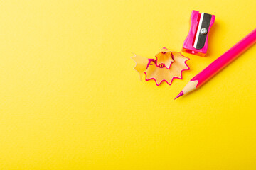 Pencil sharpener on bright colored background. Pencil and pencil shavings. Stationery. School...