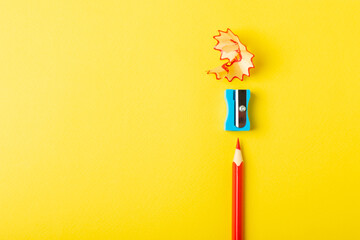 Pencil sharpener on bright colored background. Pencil and pencil shavings. Stationery. School...