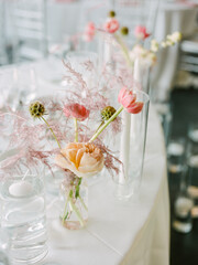 Elegant floral centerpiece with soft colors adorning a beautifully set dining table for a special event