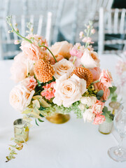 Exquisite floral arrangement featuring soft hues at an elegant event table setting