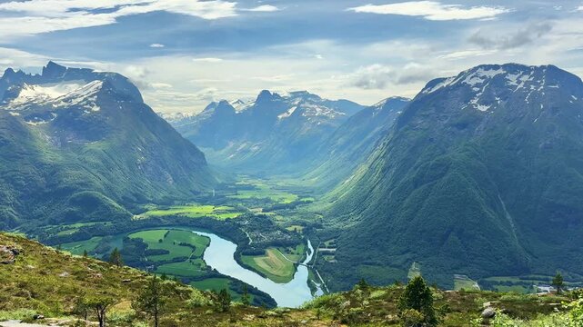 Scenic landscape showing Romsdalen valley and Rauma river, surrounded by mountains and glaciers in Norway