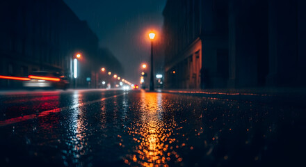  A wet city street at night reflects the warm glow of streetlights during a rainstorm with the red light trails of a passing car creating motion blur