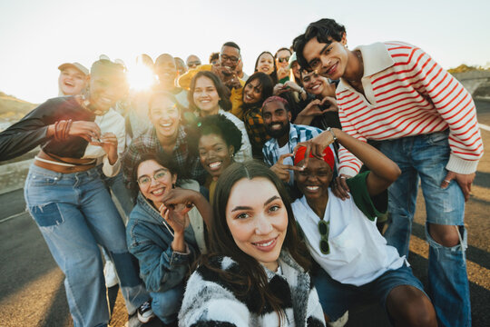 Group of young adults standing outdoors expressing unity and positivity