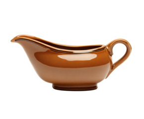 Close-up shot of a brown ceramic gravy boat with a handle.