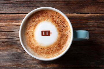 
Low battery symbol in coffee foam, representing the need for energy and a quick caffeine boost to recharge. A perfect metaphor for morning routine, work productivity, or a break.