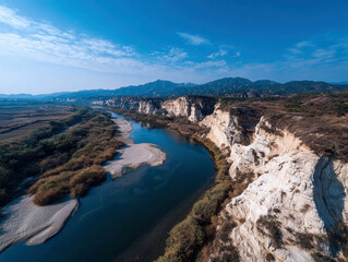 A panorama of a serene, undisturbed canyon landscape with a winding river and towering white cliffs, showcasing the interplay of light and shadow - AI-Generated