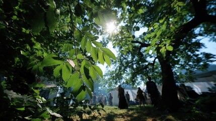 Sunlight filtering through tree leaves as festival participants take photos and enjoy ambient eclipse art installations main activity sharply detailed and background softened.
