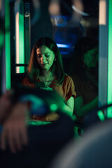 Young woman using smartphone on night bus ride home