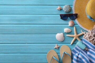Enjoy summer days with beach accessories on a blue plank background, featuring a sun hat, sunglasses, seashells, and flip flops ready for a relaxing holiday by the sea