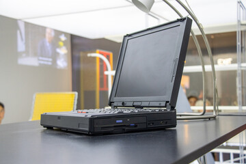 Laptop from the 1990s or early 2000s, an old personal computer on the desk.