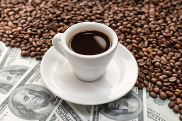 Cup of coffee on Coffee beans and dollar banknotes background