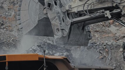 Excavator loads ore into big dump truck in open gold pit mine. Process mining industry workplace. - Powered by Adobe