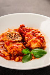 Stuffed cabbage tomato sauce with beans meat, cabbage, fresh delicious gourmet food background on the table rustic food top view copy space