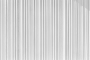 Obraz premium Decorative concrete vertical groove pattern of a building facade. Grooved White cement background