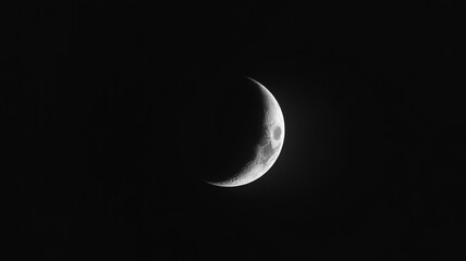 Crescent moon shines brightly against the vast darkness of space