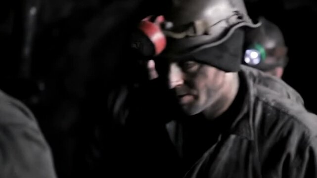 Close-up of a miner in a dark coal mine.