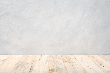 Fototapeta premium Empty wooden deck table over white textured wall background