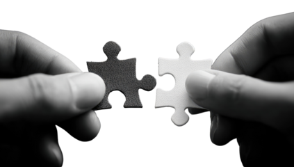 Two hands hold puzzle pieces fitting together