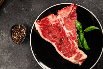 Raw steak T-bone fresh meat premium beef snack fresh delicious gourmet food background on the table rustic food top view copy space