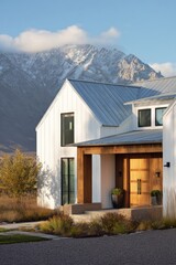 Obraz premium Modern house design located in a mountainous area with clear skies and natural landscaping, showcasing contemporary architecture with wooden accents and a welcoming entrance