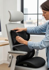Woman adjusting ergonomic chair with lumbar support in modern office setting