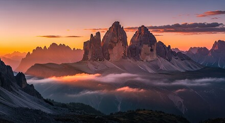 Iconic mountain peaks rising above a sea of clouds in the Dolomites at a stunning sunset.
