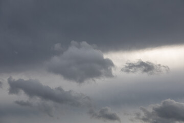Gray overcast sky with bright opening in cloud cover  
